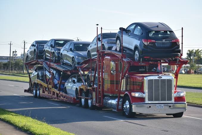 Vehicles on an open American car carrier