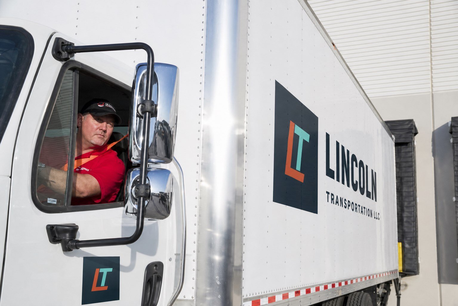 Lincoln Transportation truck and driver ready for a route